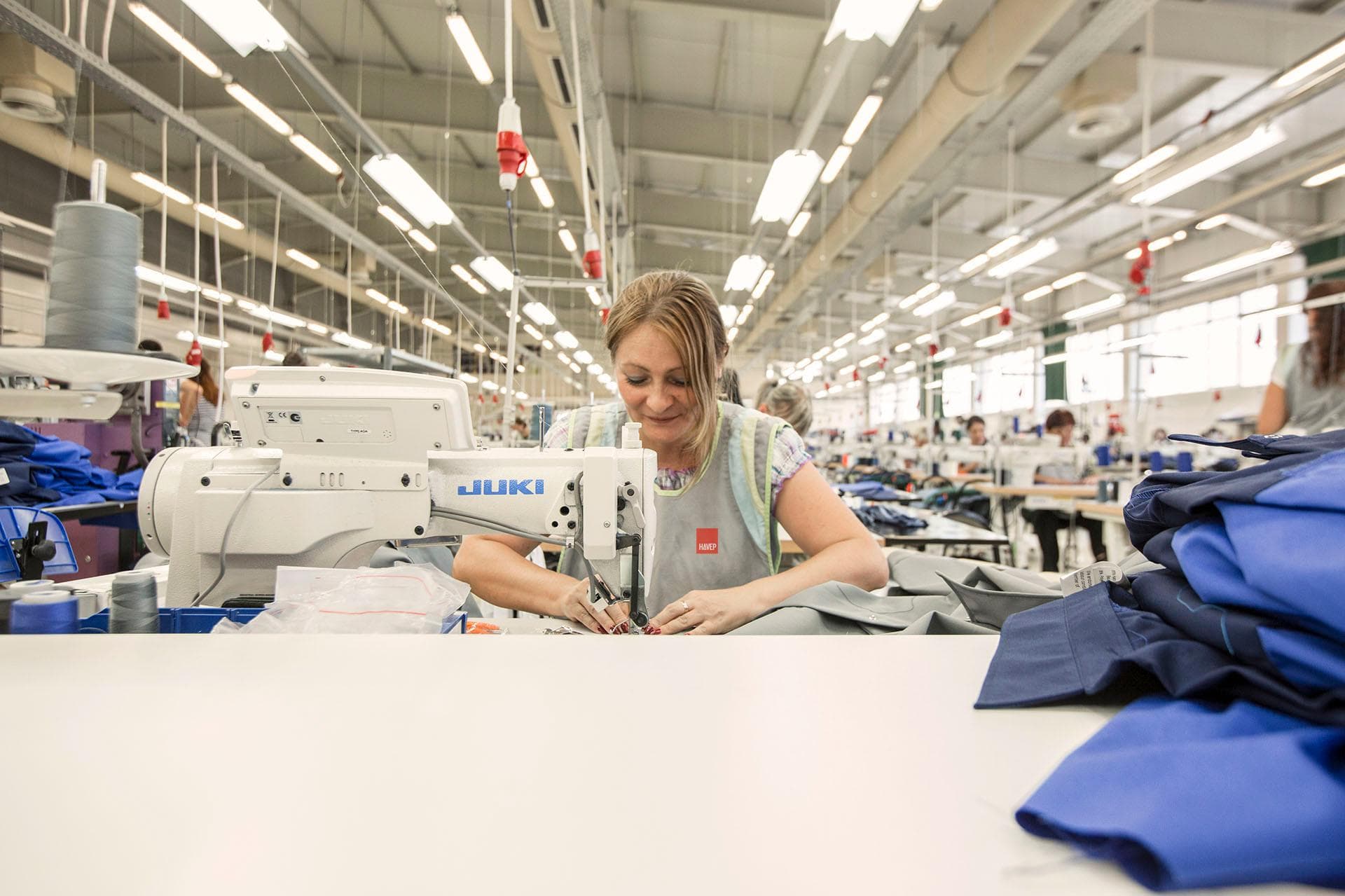 Modern garment manufacturing production floor with active sewing lines